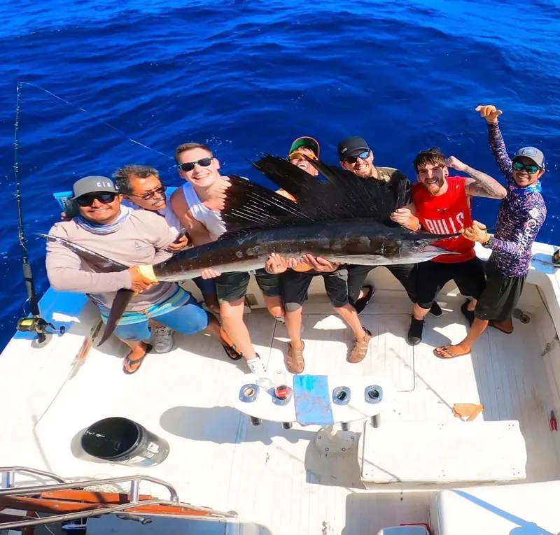 Group of anglers holding a sailfish on board